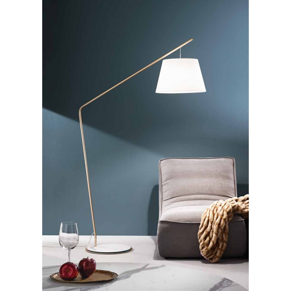 Floor lamp in gold with white shade.